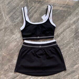 Alo Yoga solid color sports bra and skirt set with logo
